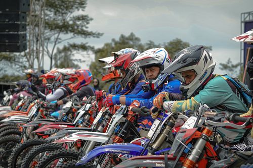 Free A thrilling off-road motorbike race underway at Yogyakarta, showcasing bikers in vibrant gear. Stock Photo