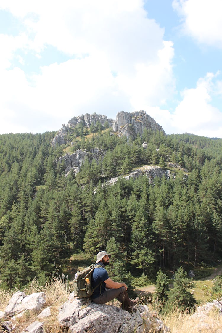 A Man Sitting On The Rock