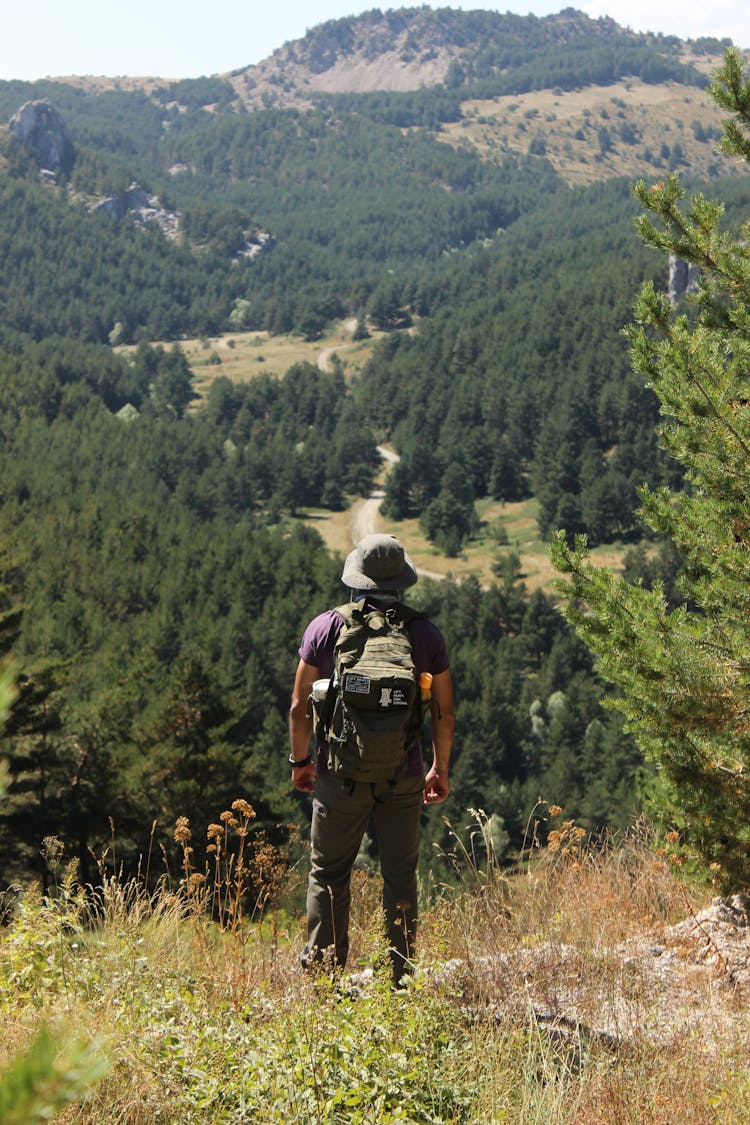 A Man Standing With Backpack