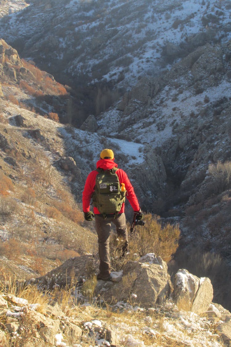 A Back View Of A Man In Red Jacket Standing On Mountain