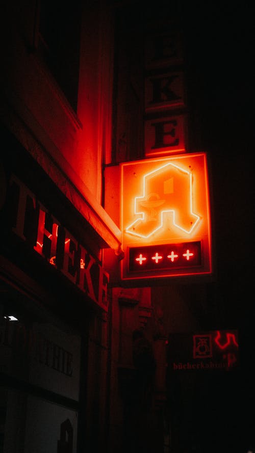 A Low Angle Shot of a Neon Lights on the Street at Night