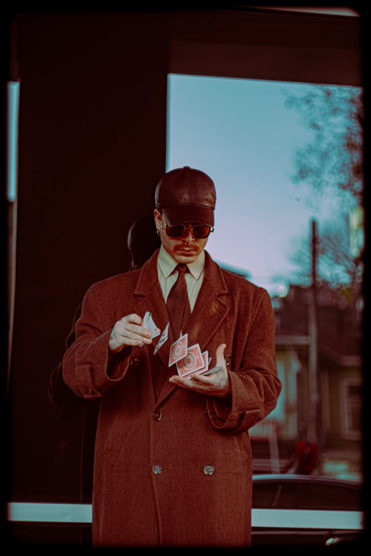 Man In Coat Shuffling Cards