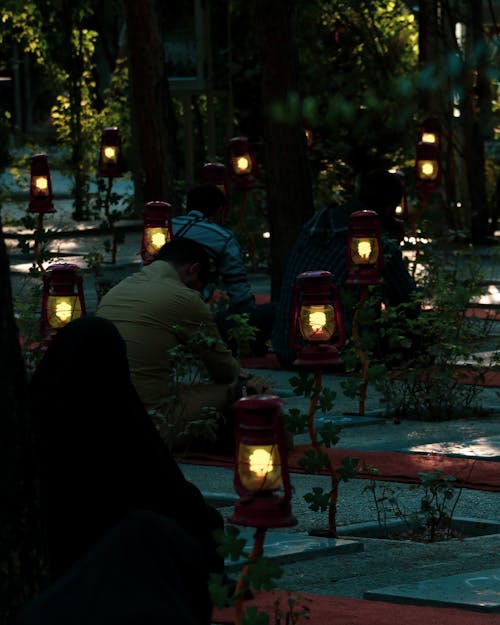 Person Gardening by Shining Lanterns
