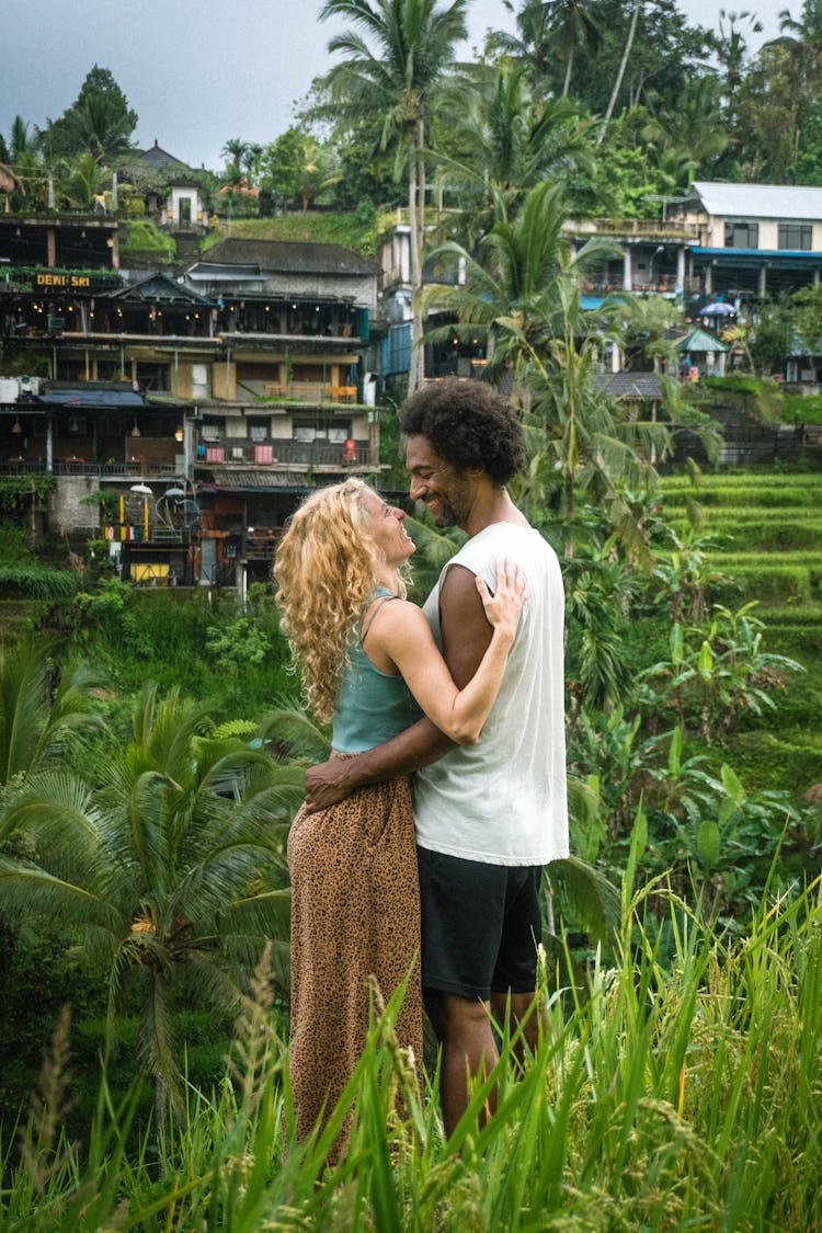 Woman And Man Smiling And Hugging In Garden