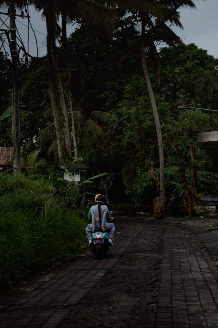 Man And Woman Riding A Motorbike 