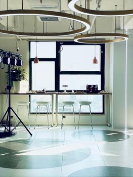 A contemporary room with stylish lighting, window view, and minimalist furniture.