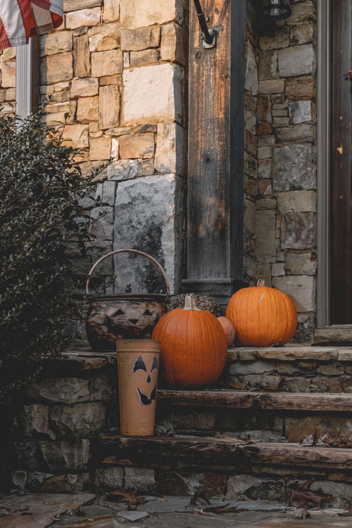Charming rustic porch decorated with pumpkins for Halloween, perfect autumn ambiance. Stock Photo.
