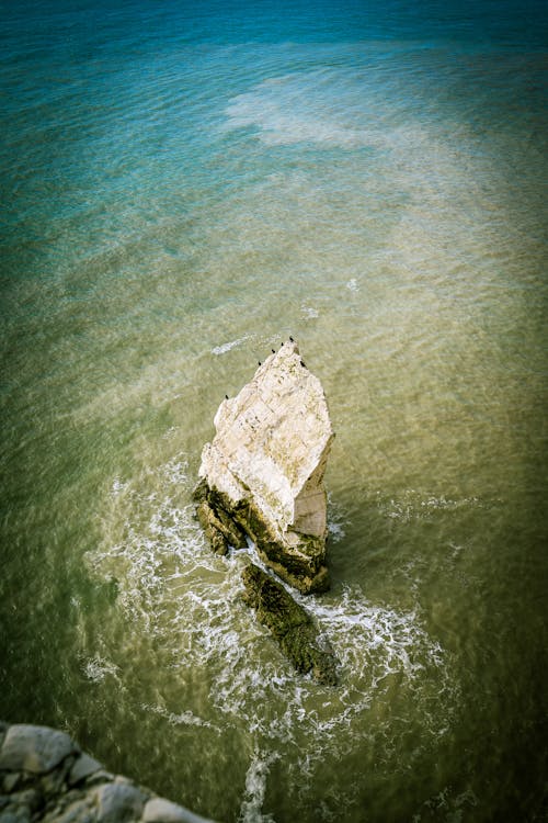 An Aerial Photography of a Rock Formation in the Middle of the Sea