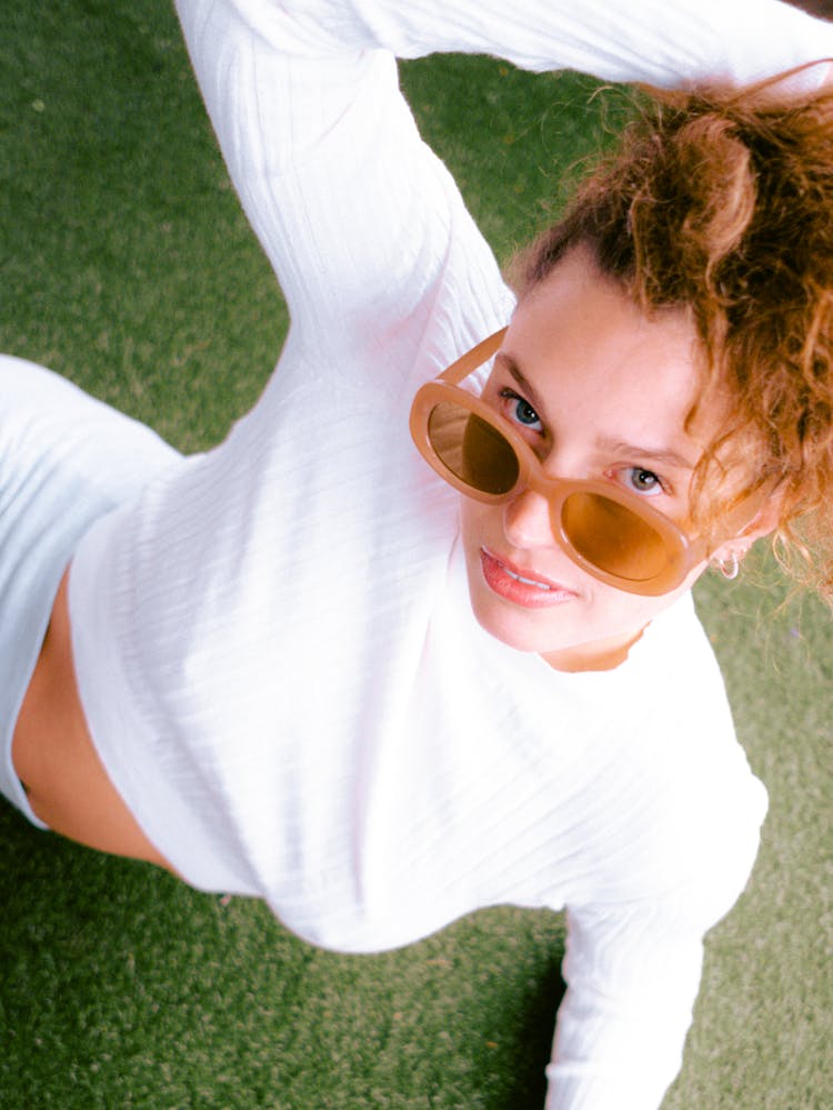 Close-Up Shot Of A Woman In White Long Sleeves Wearing Sunglasses