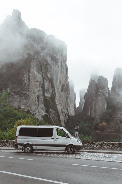 A Van Parked by a Roadside near Rock Formations