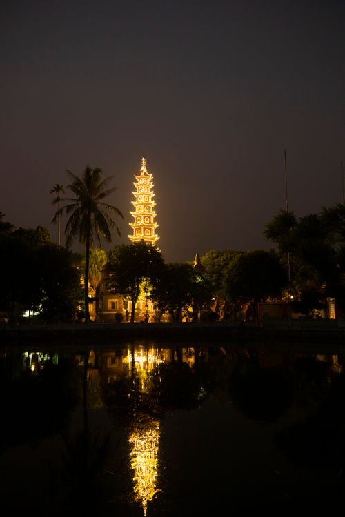 Free Night view of illuminated Tran Quoc Pagoda reflecting on the lake, Hanoi, Vietnam. Stock Photo