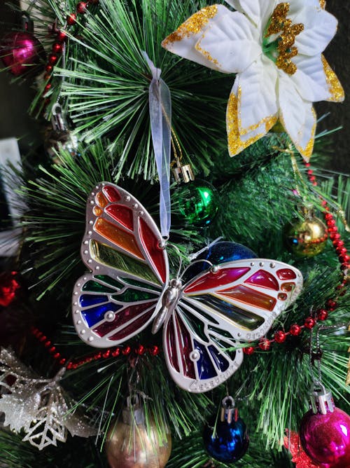 Close-Up Shot of Christmas Ornaments on Green Christmas Tree