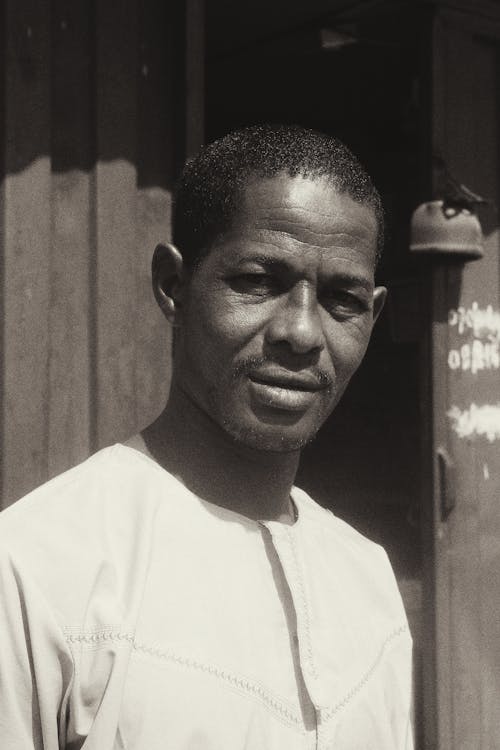 Grayscale Photo of a Man in White Crew Neck T-Shirt