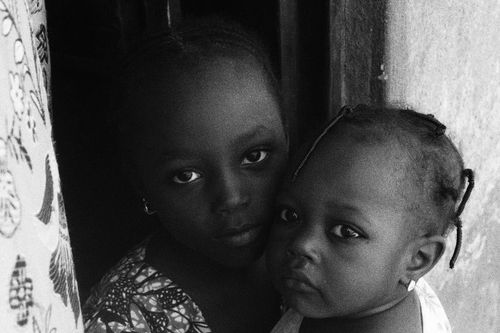 Free A touching black and white photo capturing a tender moment between two siblings in Abuja, Nigeria. Stock Photo