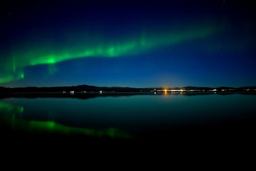 Free Breathtaking view of the Northern Lights reflecting on a lake in Ölfus, Iceland. Stock Photo