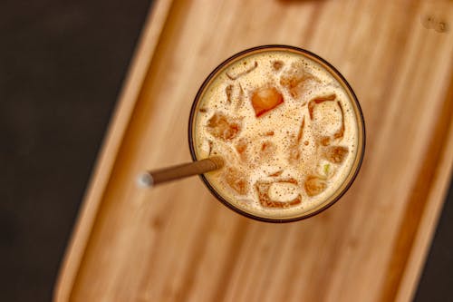 Ice Cubes in Coffee Served in Glass with Paper Straw
