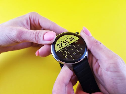 A Close-up Shot of a Person Holding a Smartwatch