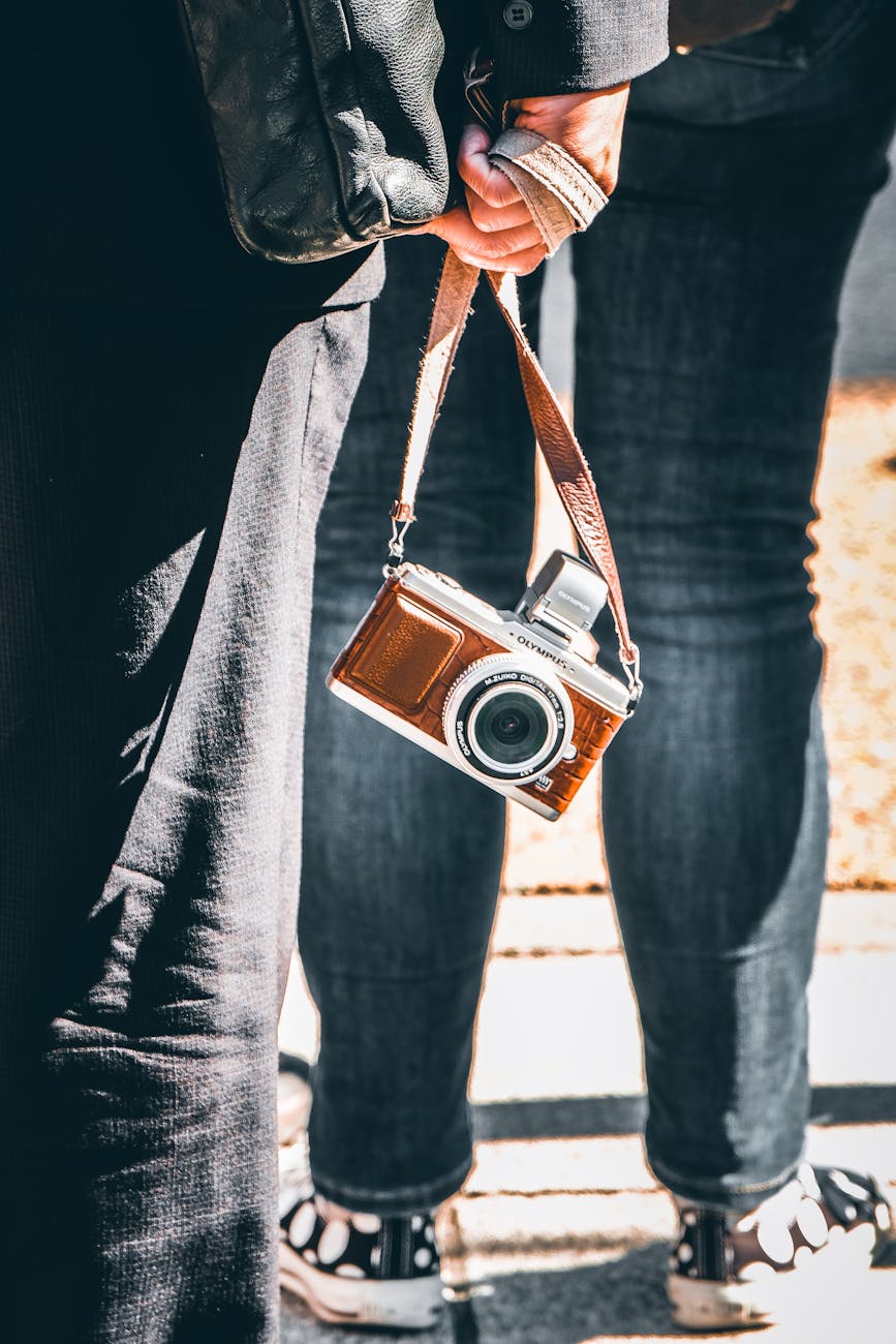 A person holding a vintage camera on the streets of Japan, capturing the essence of urban life.