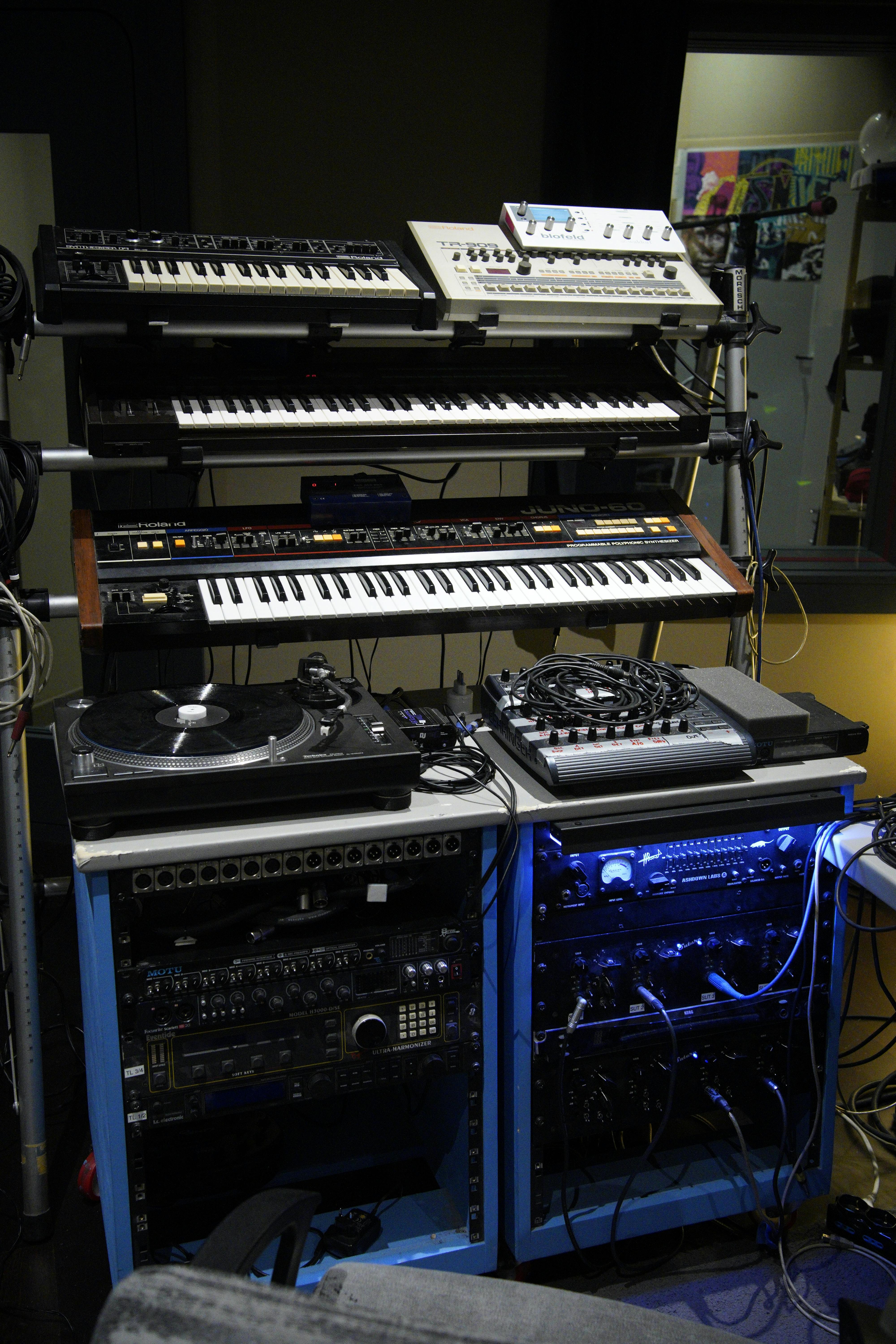 A modern and sophisticated studio with synthesizers and audio equipment for music production.