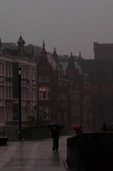 Atmospheric scene of a rainy day in Utrecht, capturing historic architecture and urban life.