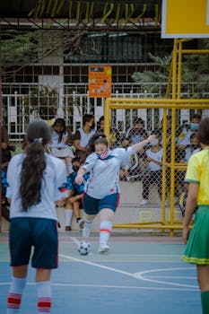 Teen girls playing indoor soccer in Guayaquil, Ecuador, showcasing energy and teamwork.