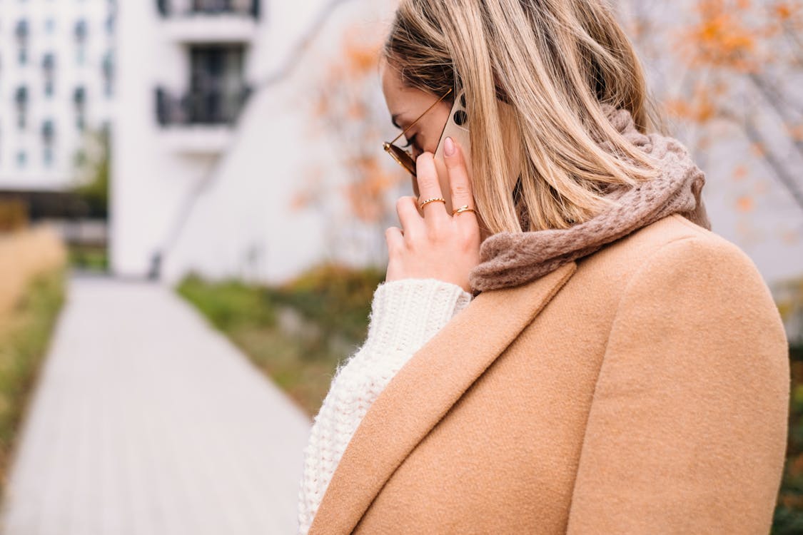 Woman in Brown Coat Talking on the Phone
