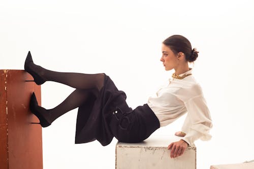 Photo of an Elegant Woman in a Black Skirt and White Shirt