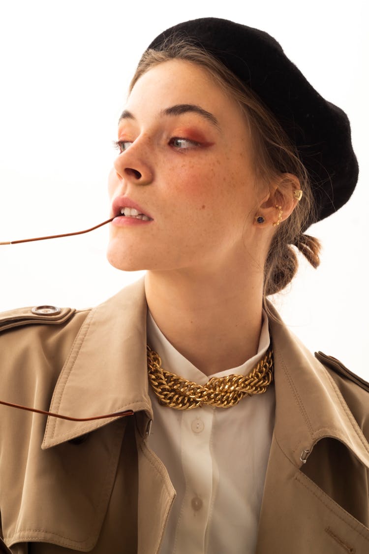 Woman In A Khaki Coat And A Beret Hat