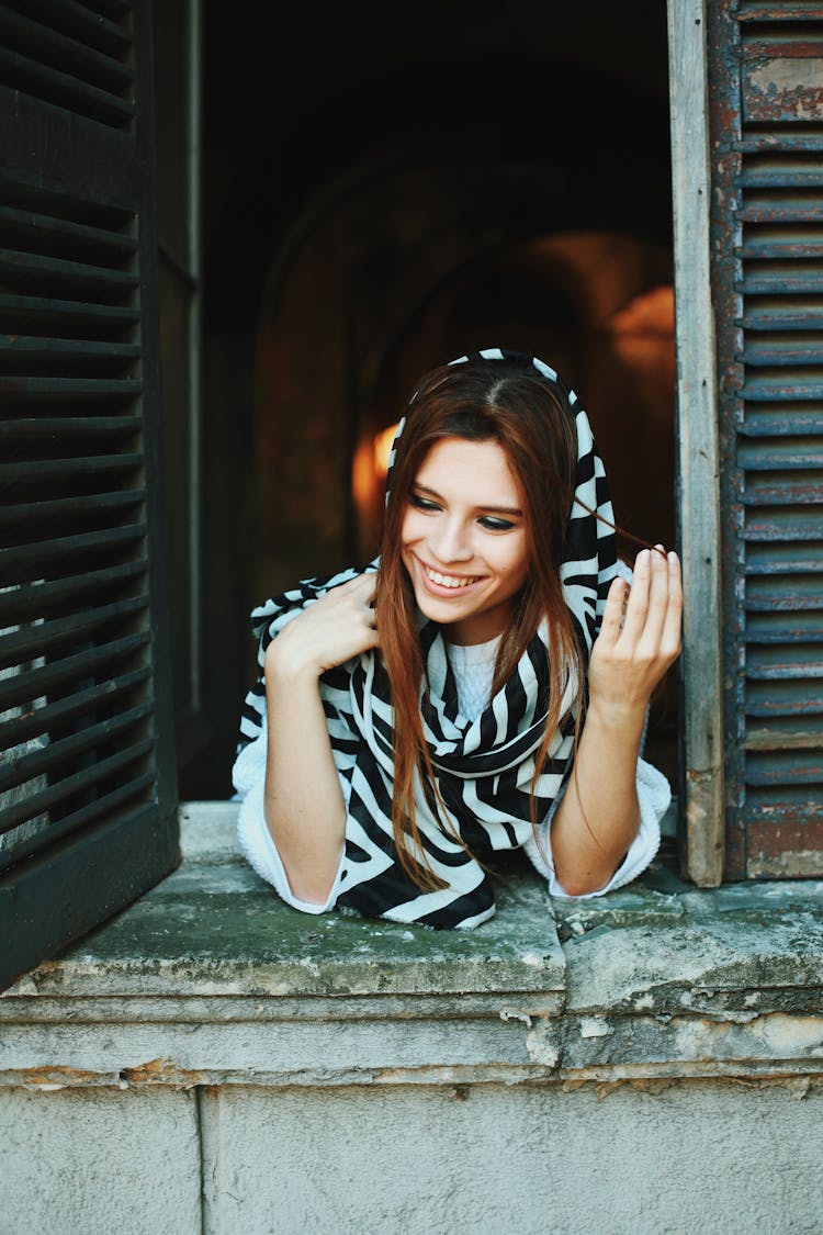 Smiling Woman Looking Out The Window 