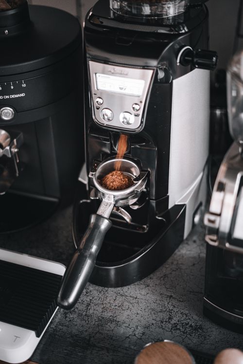 Free Close-up of a modern espresso machine grinding coffee. Perfect for cafes. Stock Photo