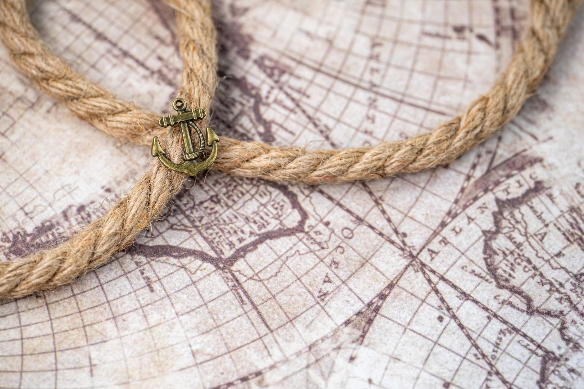 A vintage map with a nautical theme, featuring a rope and anchor symbolizing exploration.