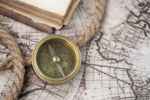 A close-up of a vintage compass on an antique world map, depicting navigation history.. close, vintage, compass