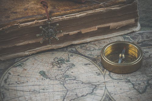 Compass and Map on a Desk 