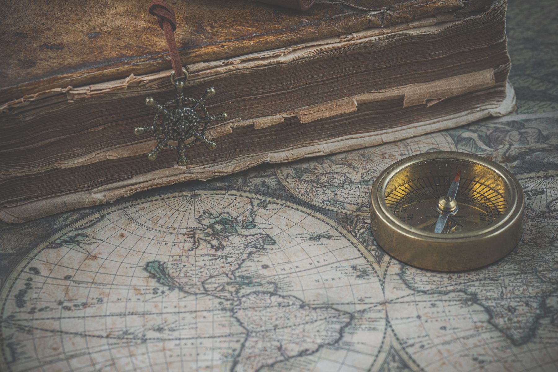 Mission notes, maps, Scripture, and journals on a dark table