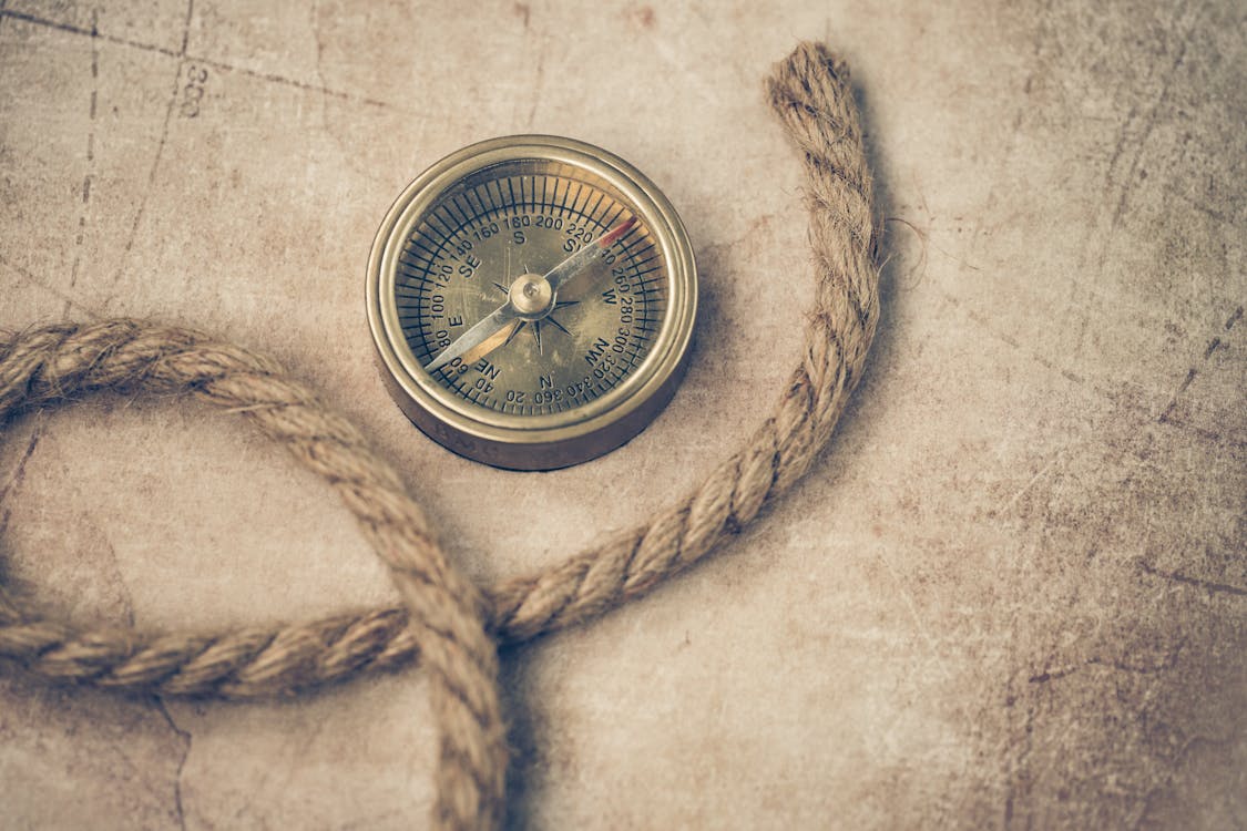 Rope and Compass on a Map · Free Stock Photo