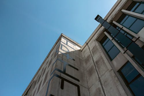 Concrete Building with Glass Windows Under a Clear Blue Sky