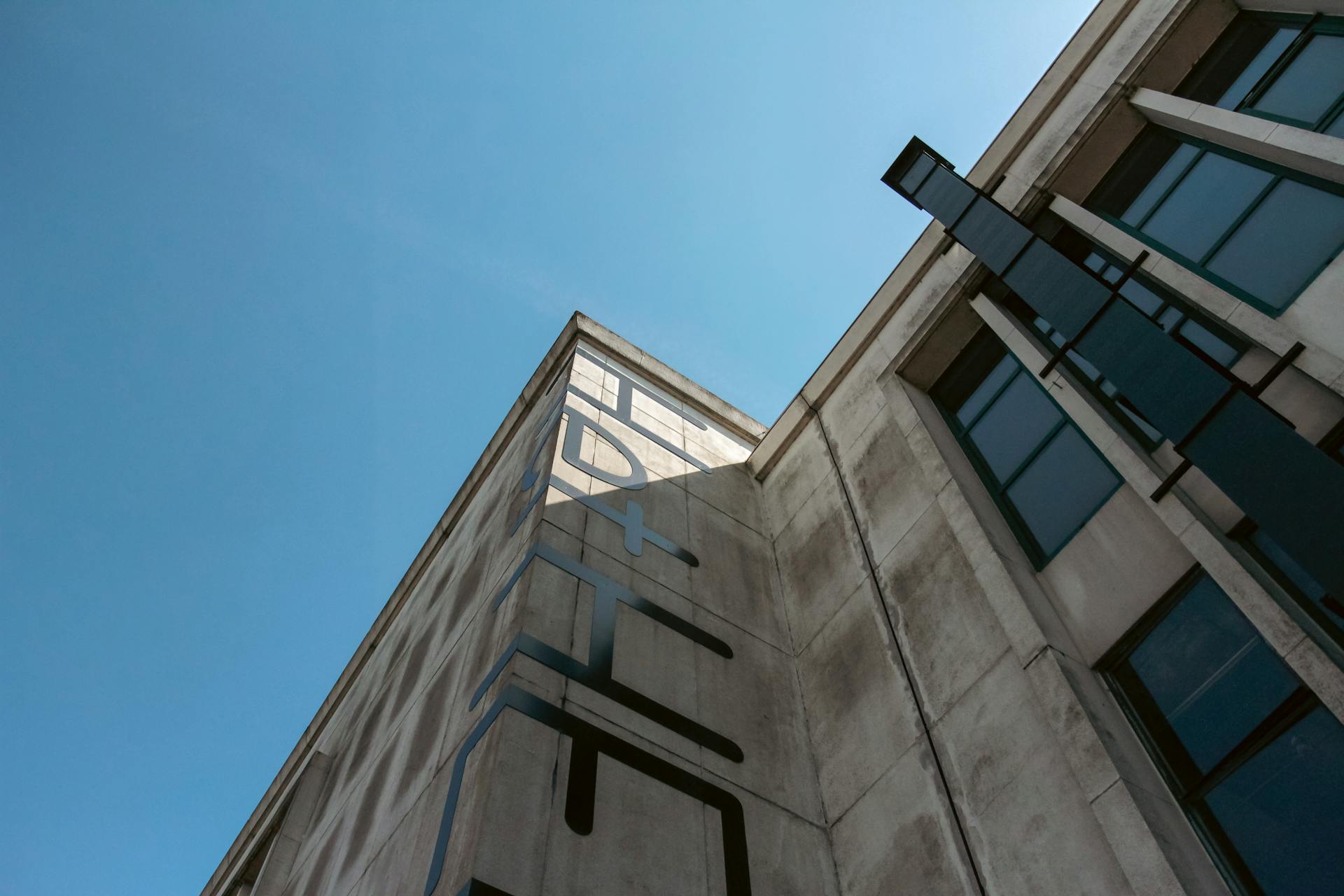 Low angle shot of a modern building facade in Zaandam with clear blue sky.