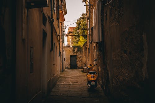 Yellow Scooter in a Narrow Alley between Traditional Buildings 