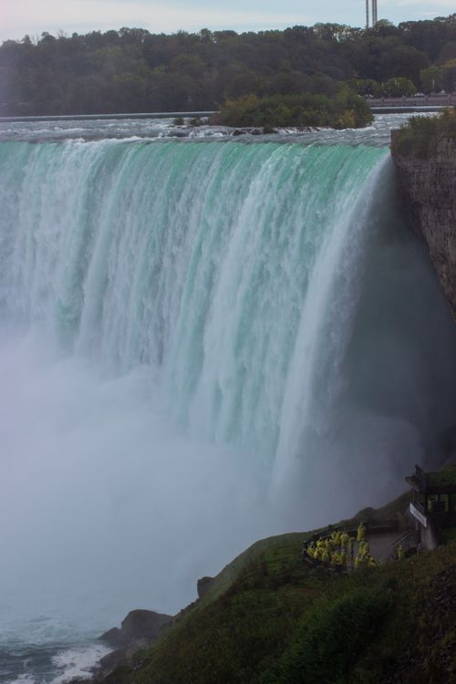 Free Stunning view of Niagara Falls, capturing the powerful cascade and mist in a serene autumn backdrop. Stock Photo
