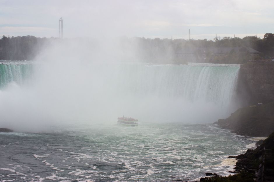 Hornblower Niagara Cruises boat approaching Horseshoe Falls in Niagara Falls, Canada