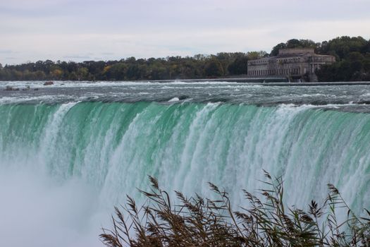 Stunning image capturing the powerful flow of Niagara Falls against an autumn backdrop.