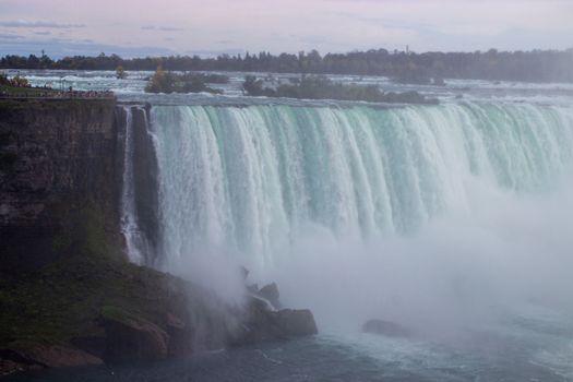 Stunning view of Niagara Falls in Ontario, showcasing powerful water flow and mist during daylight.