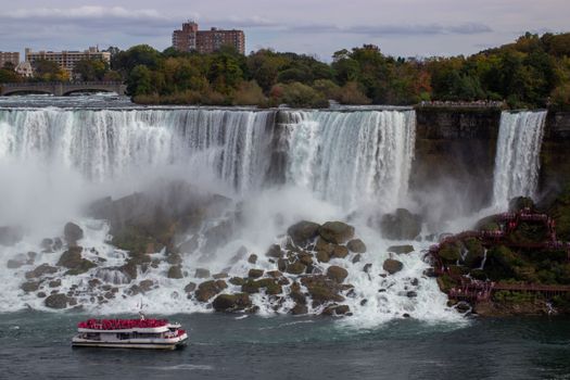 Tourist boat at Niagara Falls, Canada, showcasing the iconic waterfalls in autumn.