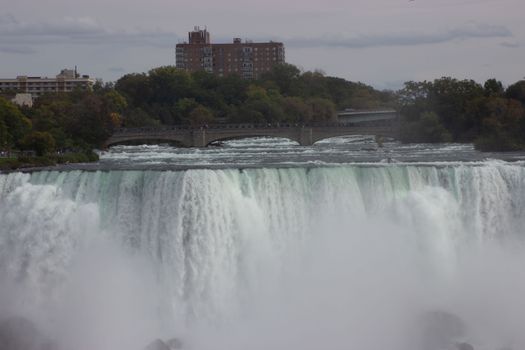 A stunning capture of Niagara Falls with a bridge and skyline backdrop, offering a natural and urban blend.