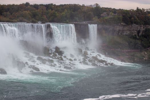 A breathtaking view of Niagara Falls with vibrant autumn trees and cascading water.
