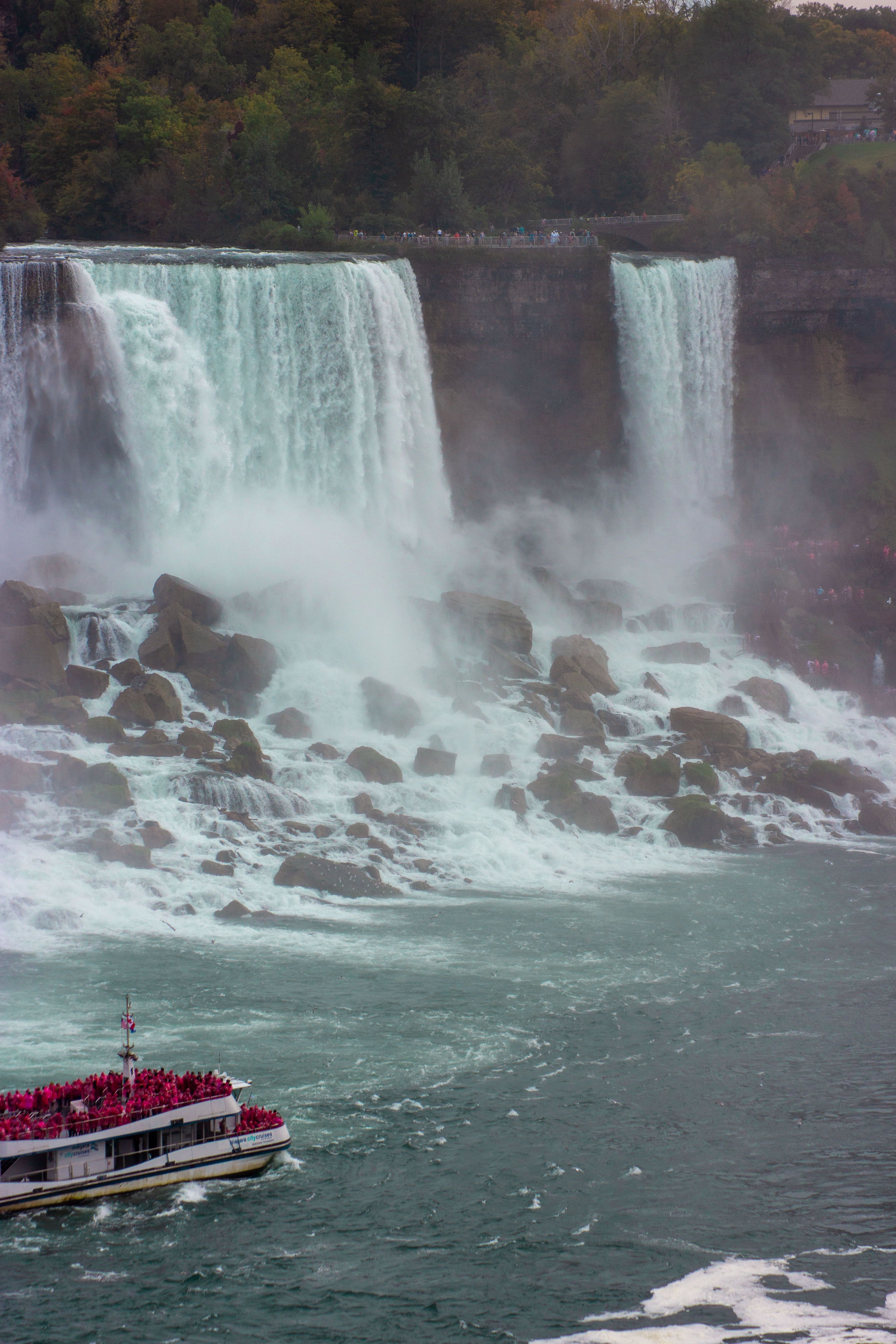 Experience the majestic Niagara Falls with a tour boat navigating the powerful waters.