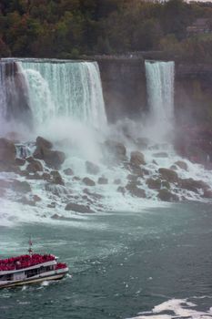 Experience the majestic Niagara Falls with a tour boat navigating the powerful waters.