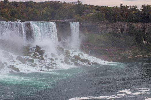 Experience the majestic beauty of Niagara Falls during the vibrant autumn season.
