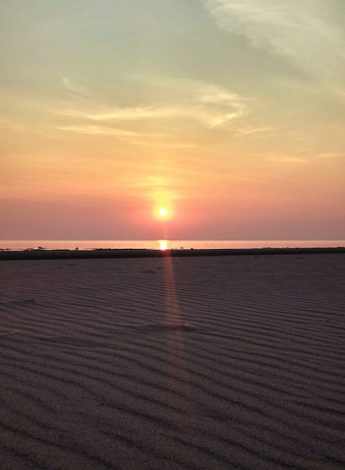 Free Sun Setting on Horizon on Beach Stock Photo