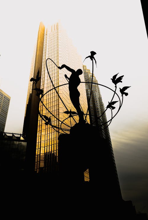 Silhouette of Sculpture with Skyscrapers in Background